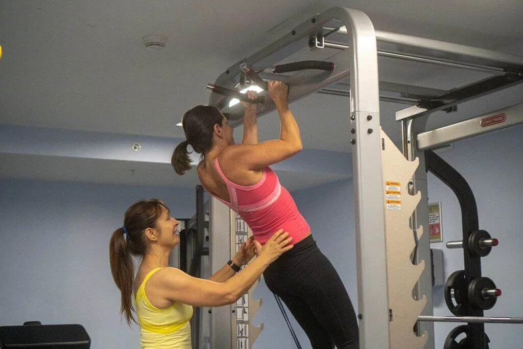 Coach Lil personal trainer demonstrating pull-ups Palm Beach